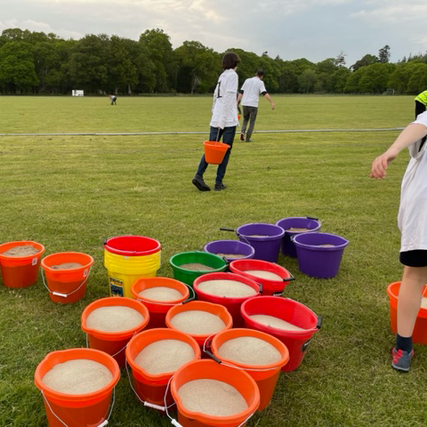 NFPC Ground Maintenance Members of NFPC add sand to the polo field by hand using buckets